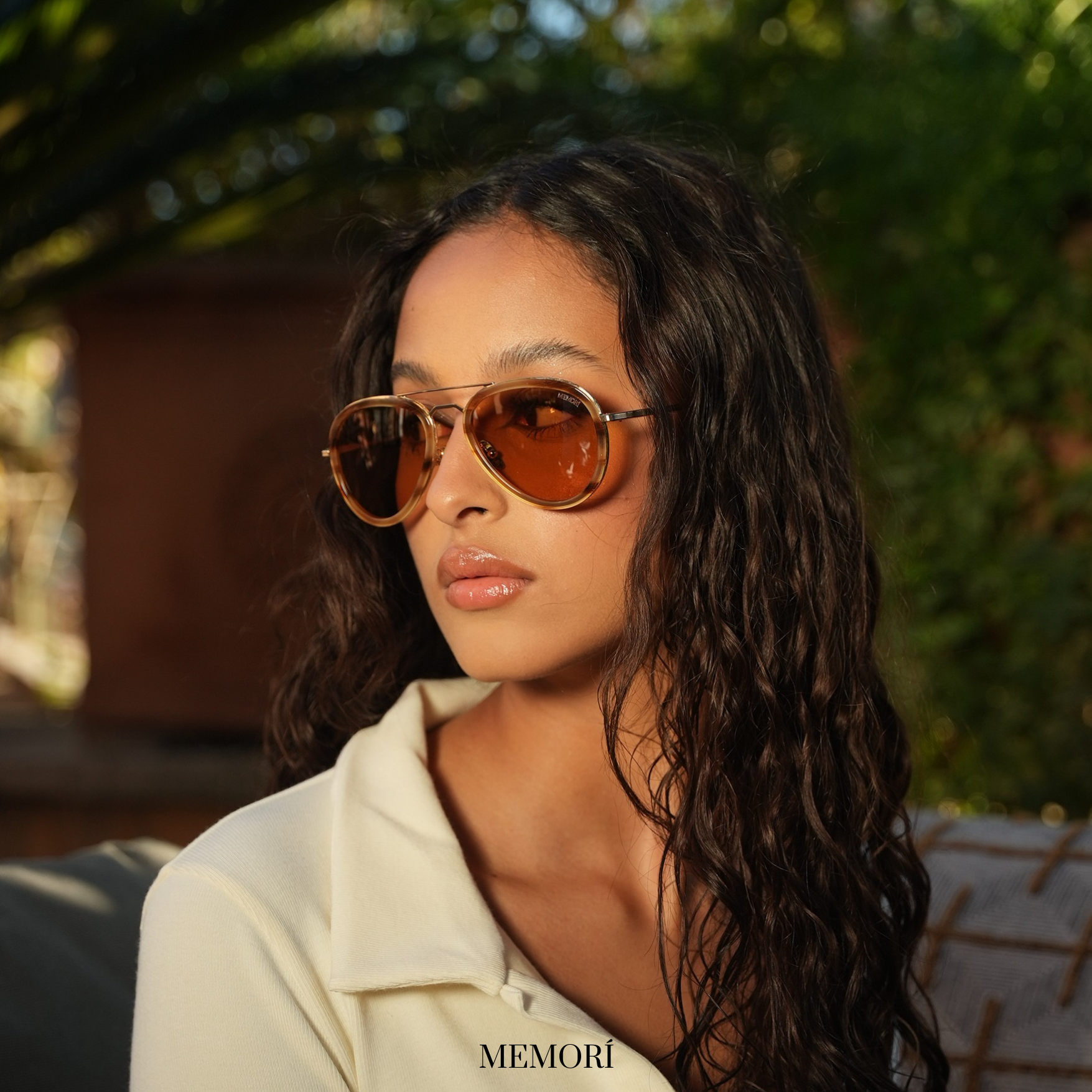 Image of model wearing small fit aviator sunglasses with light brown, almost yellow lenses. Aviators have a tortoise shell pattern acetate rim, and are smaller than the average pair of sunglasses to complement the model's petite face and features.