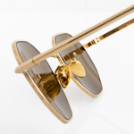 Gold hexagon Memorí sunglasses with warm brown lenses. Macro view to show gold nose pads and geometric pressed edge detailing. Narrow width. Best sunglasses for small faces. Made in Italy.
