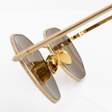 Gold hexagon Memorí sunglasses with warm brown lenses. Macro view to show gold nose pads and geometric pressed edge detailing. Narrow width. Best sunglasses for small faces. Made in Italy.