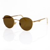 best gold round sunglasses for small faces, this photo of Memorí round sunglasses in gold show the unique angular nose bridge and scalloped temple arms. handmade in Italy to be the best fitting sunglasses for small and narrow faces. 