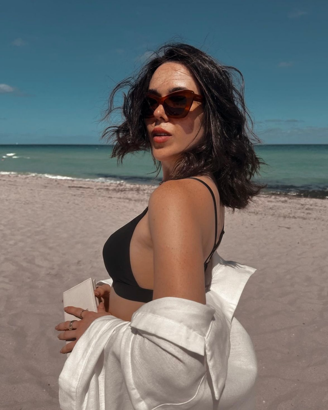 customer review for tortoise cat eye sunglasses. Shown on the beach in Miami.
