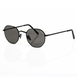 3/4 view of black sunglasses designed for small face shape. Features black polarized lenses and black metallic ceramic nose pads.