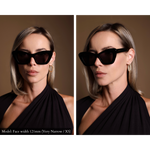 Model wearing very elegant, angular black sunglasses. Model has a very narrow face, and the sunglasses look great and do not overpower her features.