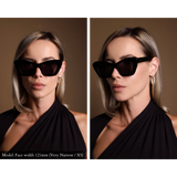 Model wearing very elegant, angular black sunglasses. Model has a very narrow face, and the sunglasses look great and do not overpower her features.
