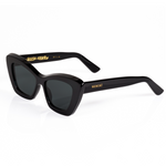 3/4 view of Memori black cat eye sunglasses. The design is sleek and elegant. This view shows of the top beveled edge, and the gold laurel dealing inside the temple arm. Memori logo in gold also appears as a small metal badge set into the acetate on the external temple arm.
