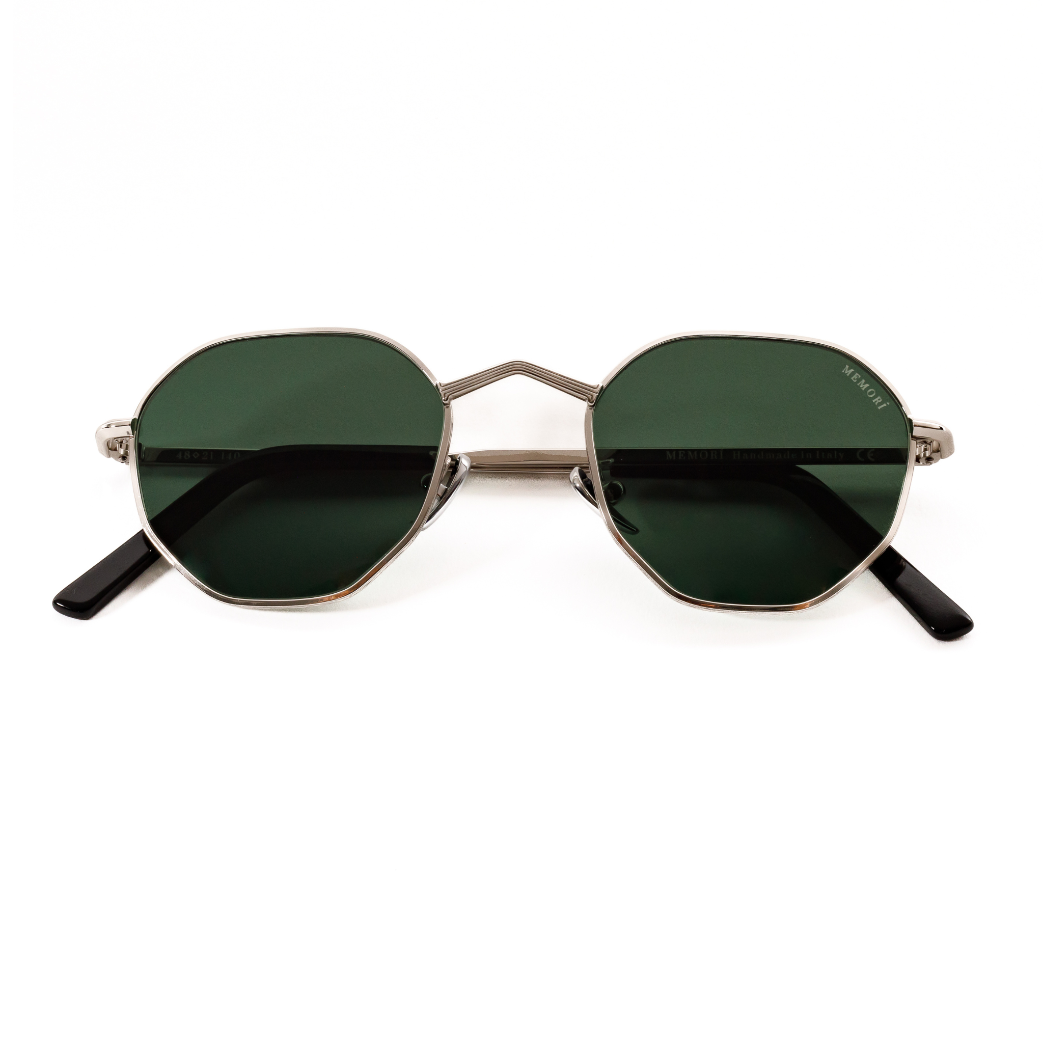 Memorí small fit designer sunglasses. folded view shows etched detail in nose bridge and green lenses.