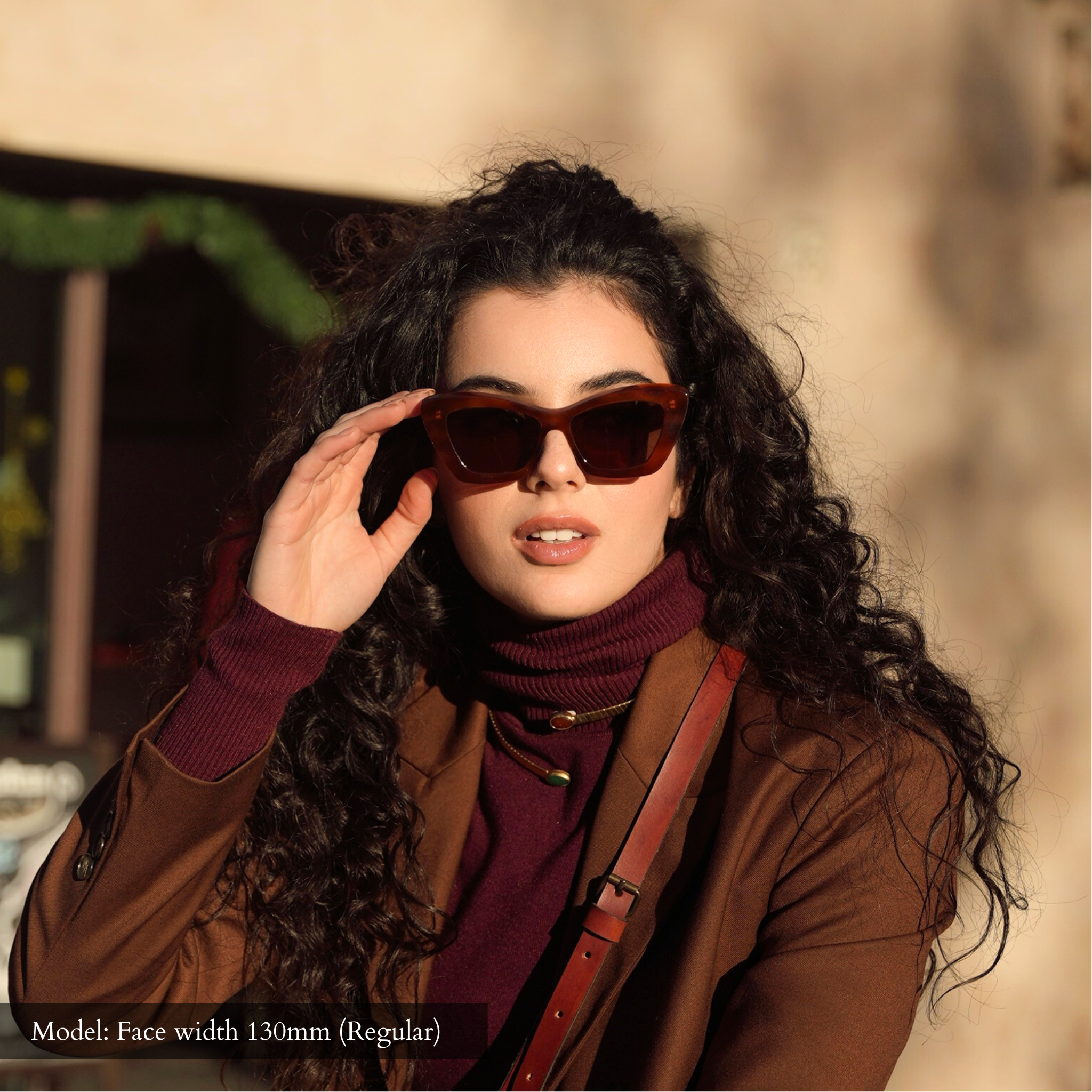 Model with regular width face wearing Memorí small fit sunglasses, which are designed specifically for petite faces. 