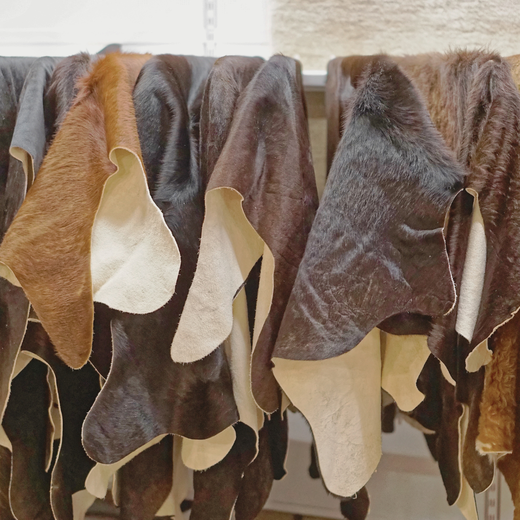 leather hides hanging on a bar