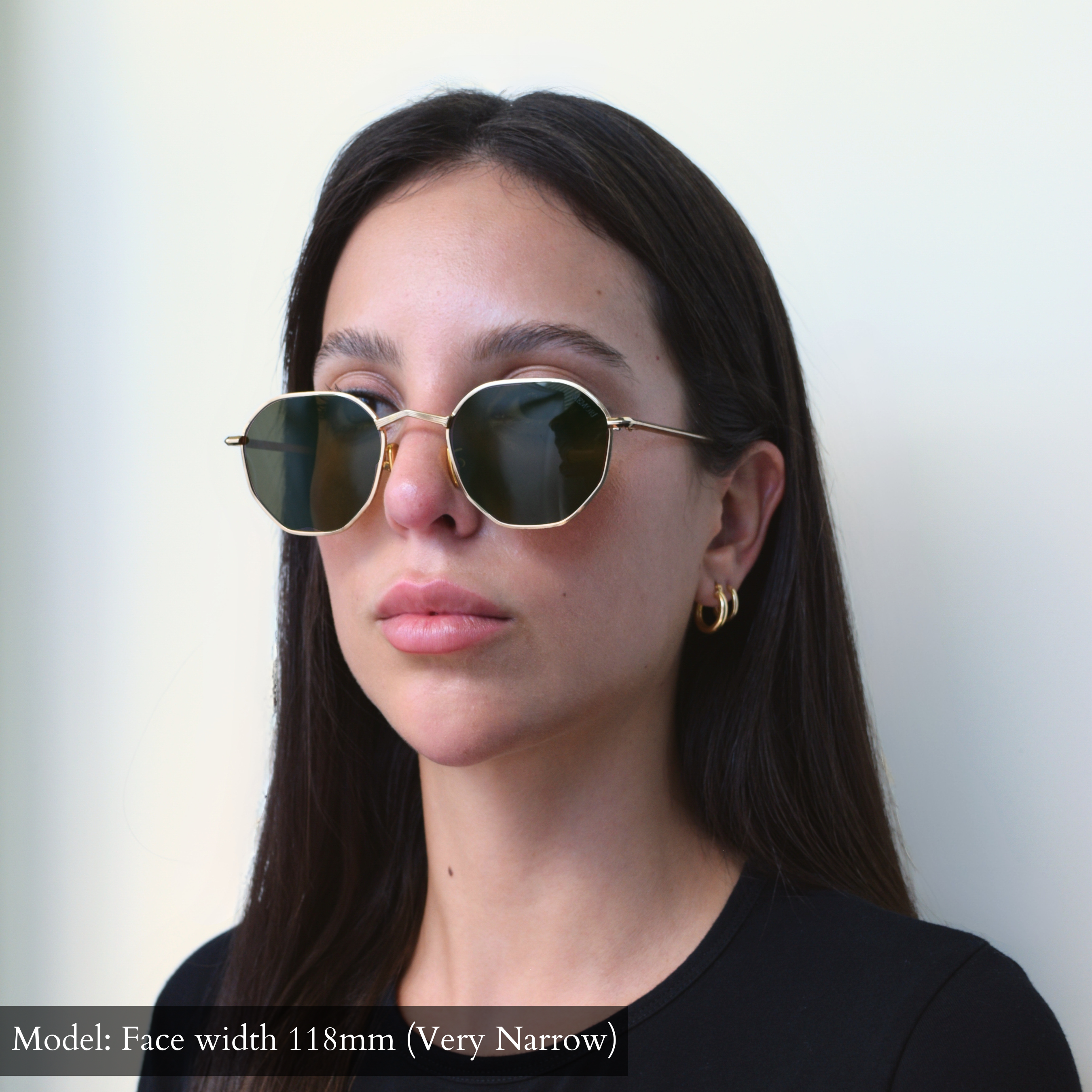 Gold Memorí hexagon metal sunglasses with V shaped nose bridge, gold nose pads, and geometric pressed metal eye rim detailing. Photo shows sunglasses on model. Model has a very narrow face, and these frames fit her well. Sunglasses are designed to fit smaller faces.