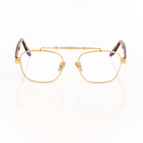Gold-framed eyeglasses on a white background. Brown tortoise temple arms made of acetate with transparent lenses. 
