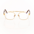 Gold-framed eyeglasses on a white background. Brown tortoise temple arms made of acetate with transparent lenses. 