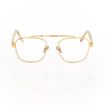 Front view of Memori Balaustra Aviator glasses on a white background. transparent lenses, gold frame, and ivory and light brown marbled acetate temple arms. Top bar has sculptural gold design details. 