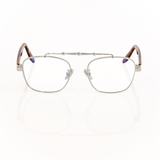Front view of memori balaustra aviator optical frames in silver with transparent lenses, brown tortoise acetate temple arms, and a sculptural silver horizontal top bar on a white background. 