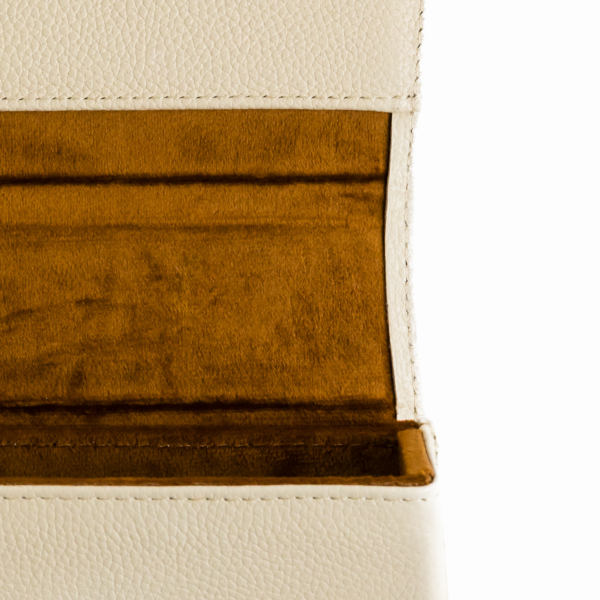 Detail view of the inside of a memori eyewear case. Protective case has a hardshell exterior which is covered in an ivory toned pebbled leather. The inside shows a warm brown colored velvet lining.  Every purchase of a pair of Memori sunglasses includes a handmade genuine leather protective sunglass case such as this one pictured. 