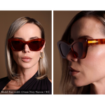 Model wearing angular cat eye sunglasses with tortoise shell pattern, facing front and side view. Gold Memori logo is visible on external temple arm.