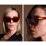Model wearing angular cat eye sunglasses with tortoise shell pattern, facing front and side view. Gold Memori logo is visible on external temple arm.