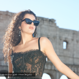 Model with average width face wearing memori black cat eye sunglasses in Italy