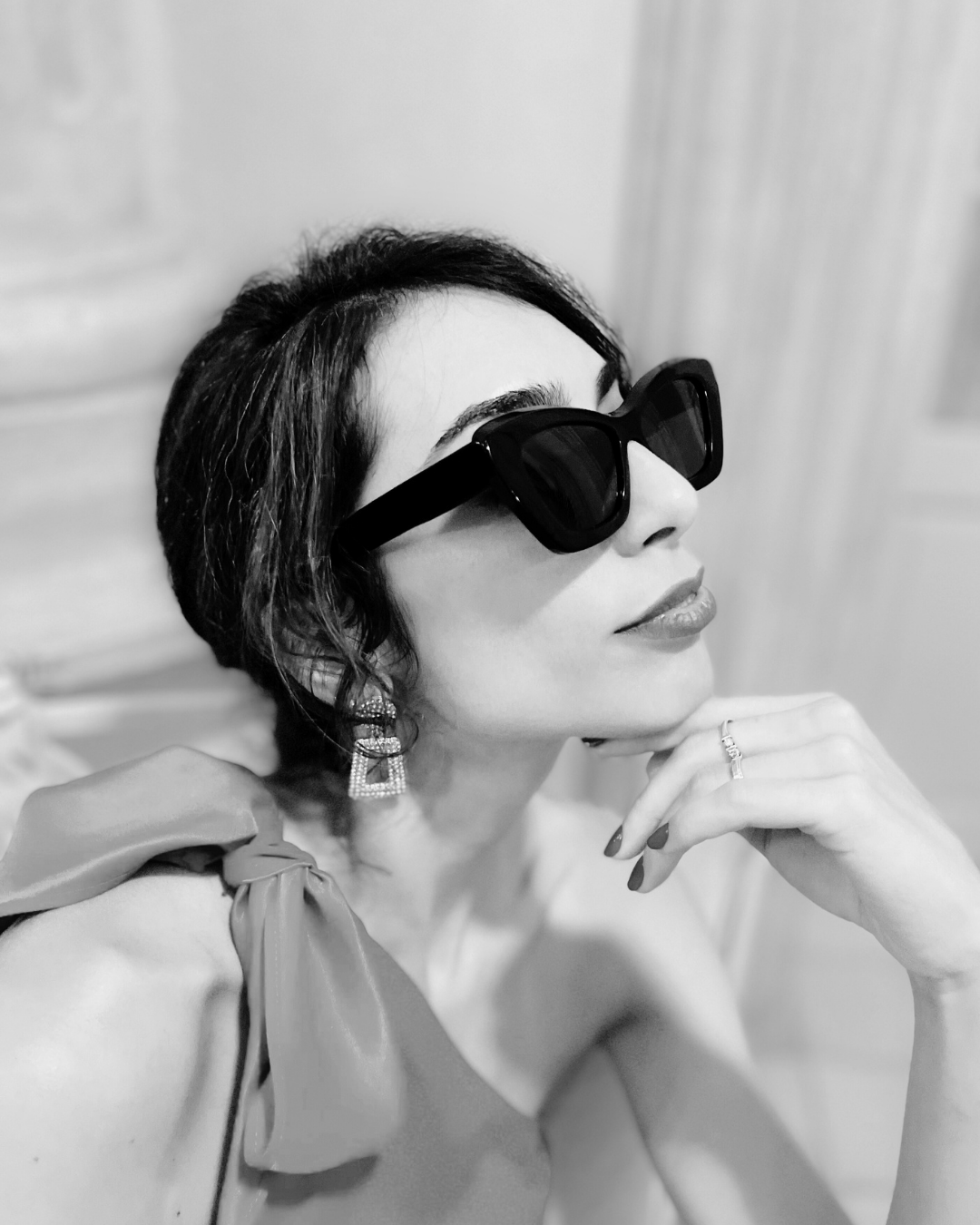 beautiful black and white photo of woman wearing black Memori cat eye sunglasses, the best sunglasses for petite faces