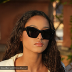 model with small face wearing memorí cat eye sunglasses for small faces in color black. Best fitting sunglasses for petitie faces. view shows angled top bevel detail. 