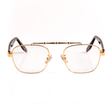 gold, metal frame blue light blocking glasses with transparent lenses, tortoise temple arms and a detailed metal upper brow bar on a white background. 