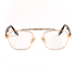 gold, metal frame blue light blocking glasses with transparent lenses, tortoise temple arms and a detailed metal upper brow bar on a white background. 