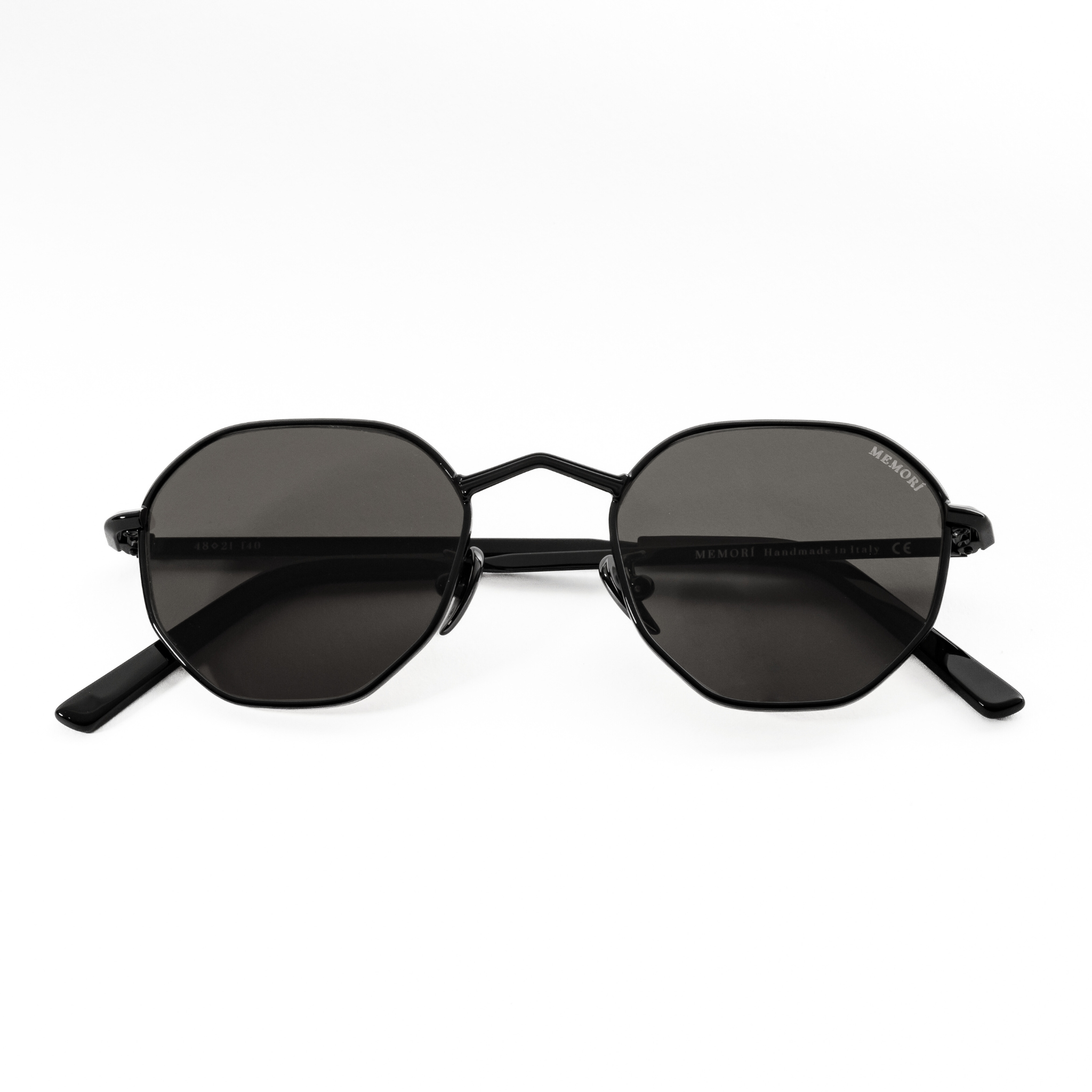 Product photo of Memorí black hexagon small fit sunglasses. Folded position shows the geometric V nose bridge shape, which is elegant yet edgy and elevates the design. 